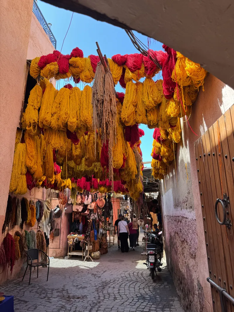 Colorful skeins of yarn hanging in a Marrakech street